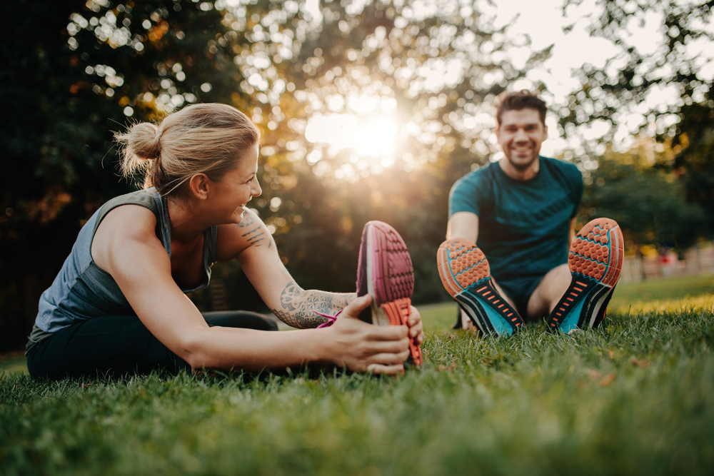 Happy Couple Stretching Outdoors