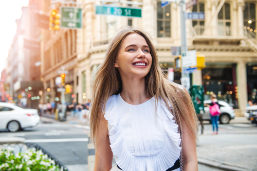 Smiling Young Woman on City Street