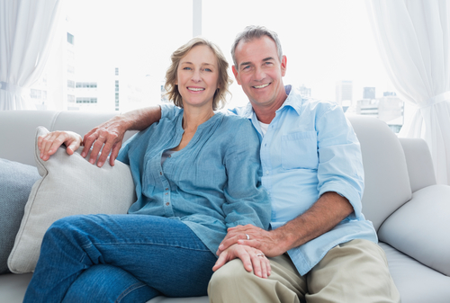 couple sitting on a couch and smiling