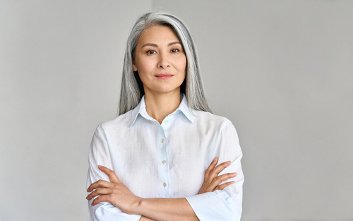 Old lady with her arm crossed and a positive look