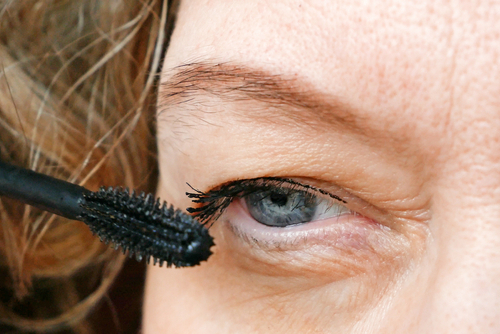 woman applying eyelash makeup