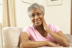 woman smiling while sitting on couch