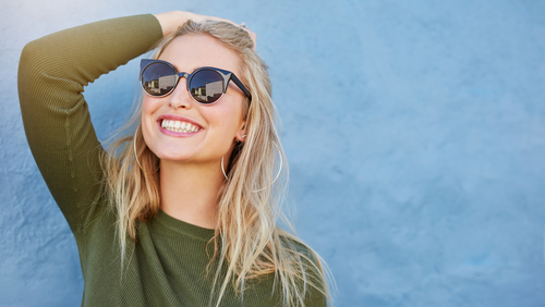 woman in green shirt and black sunglasses 