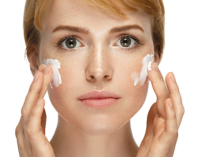 Woman Applying Cream for Skin Care