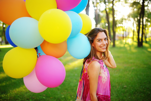 Woman with balloons in park