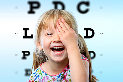 Child laughing during a visit to their pediatric ophthalmologist